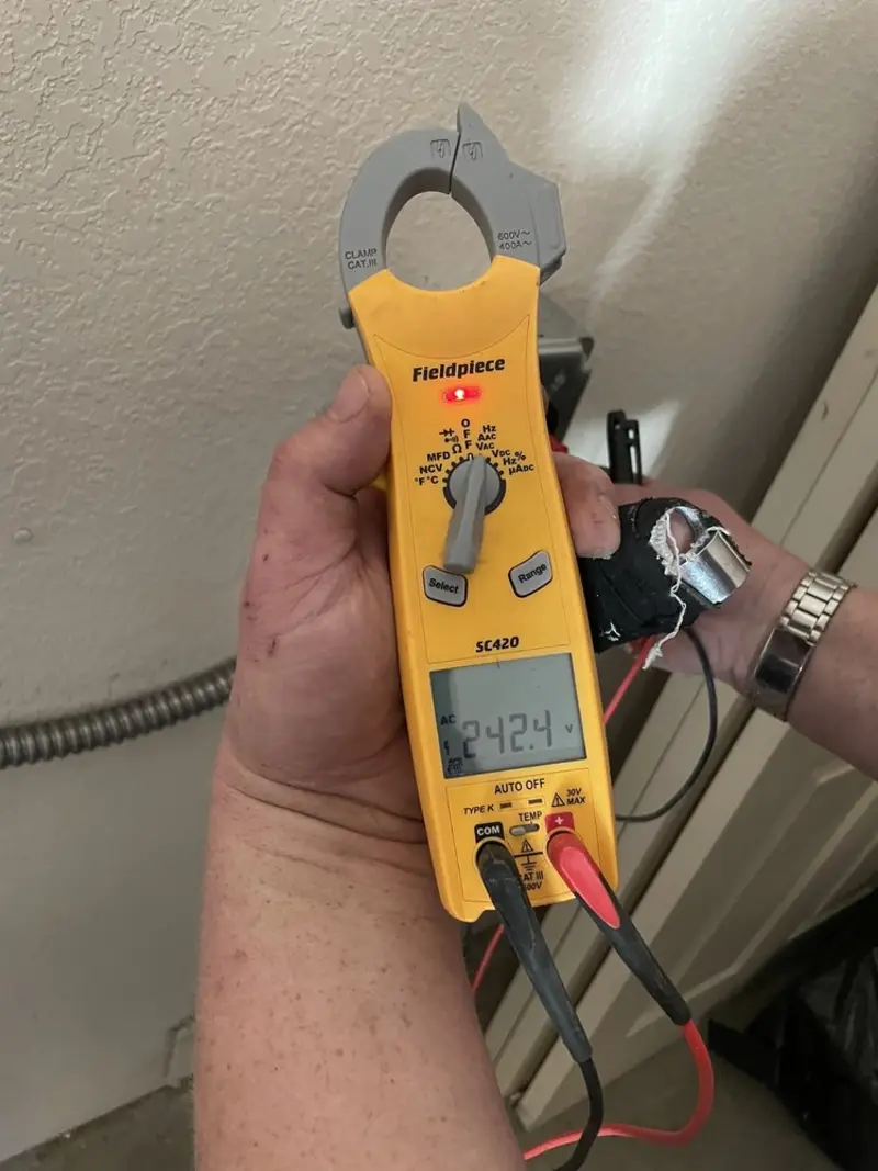 Voltage testing with clamp meter during Outlet Installation in Oakland